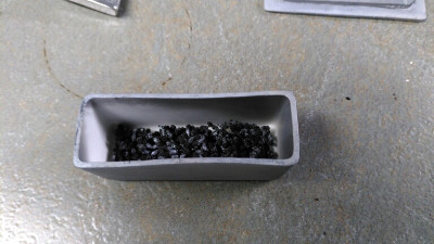 0.4 grams of carbonized yew microstrobili in blackened crucible