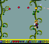 Rayman grimpant sur une liane dans Rainy Forest.