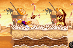 Rayman se baissant pour éviter le projectile du cake vampire.