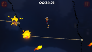 Rayman sautant d'une tyrolienne à l'autre au milieu des boules de feu.