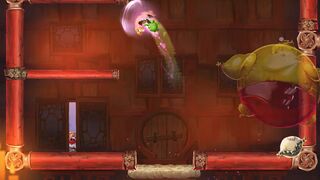 Rayman defeating an Oger, with the Captain barely visible.