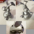 The rare silver version of the figure of Rayman sitting in a plum.